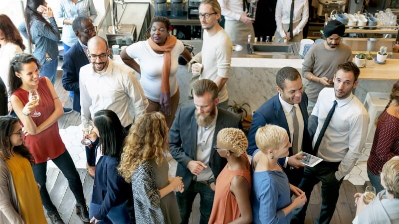 An image of people networking and sharing referrals.