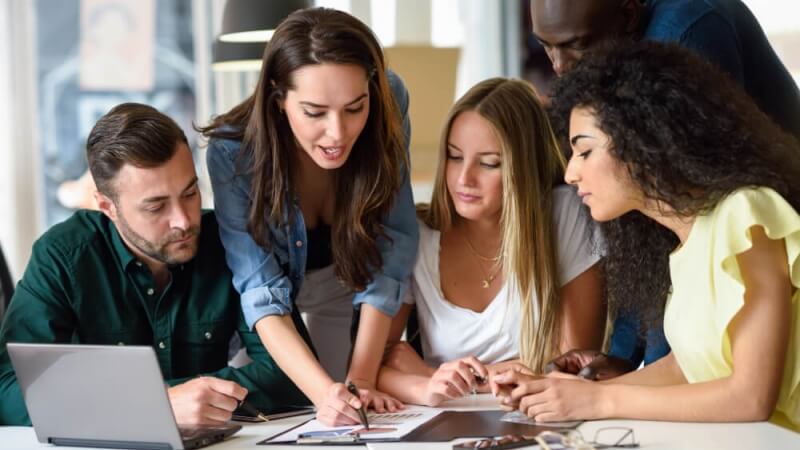 An image of people working together to support a page listing our UK sales training programmes.