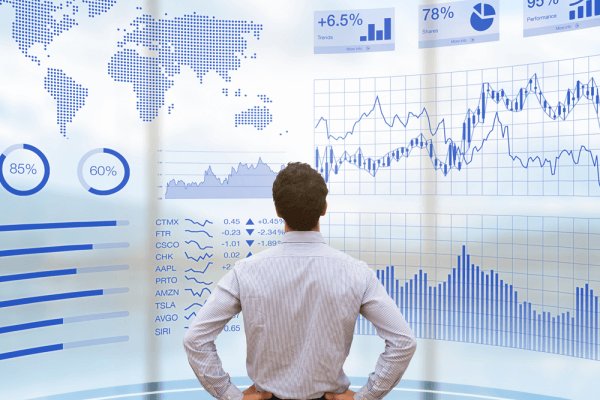 A picture of a businessman reviewing benchmarking data to support a page about business performance management.